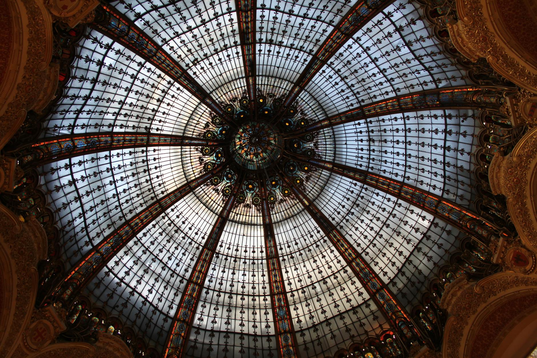 Elegant Belle Époque department store interior with grand glass canopy and iron framework in Paris