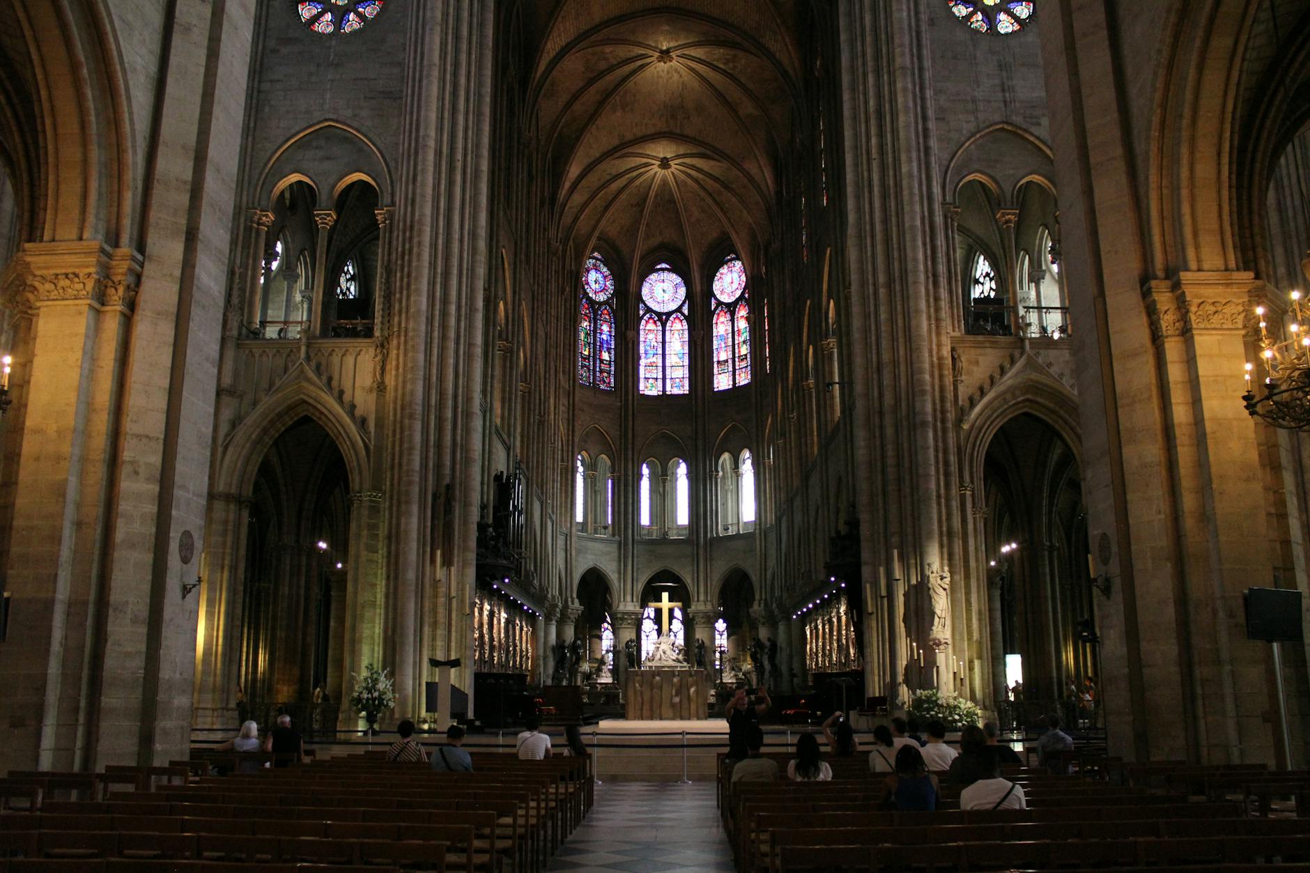 A majestic view of the Notre-Dame Cathedral interior in Paris, showcasing Gothic architecture.