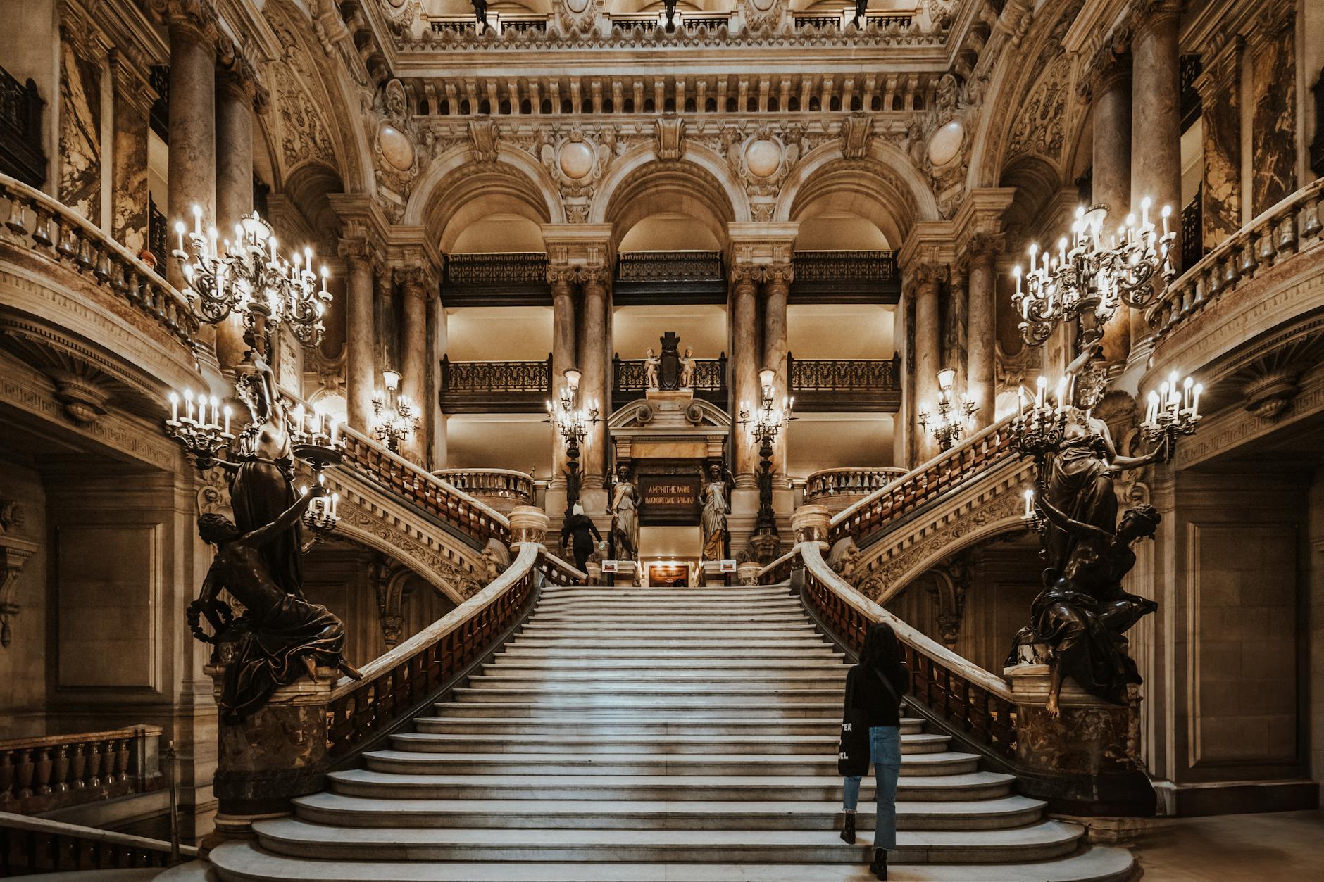 Elegant evening scene at Palais Garnier opera house with velvet seats, gold details, and chandelier glow