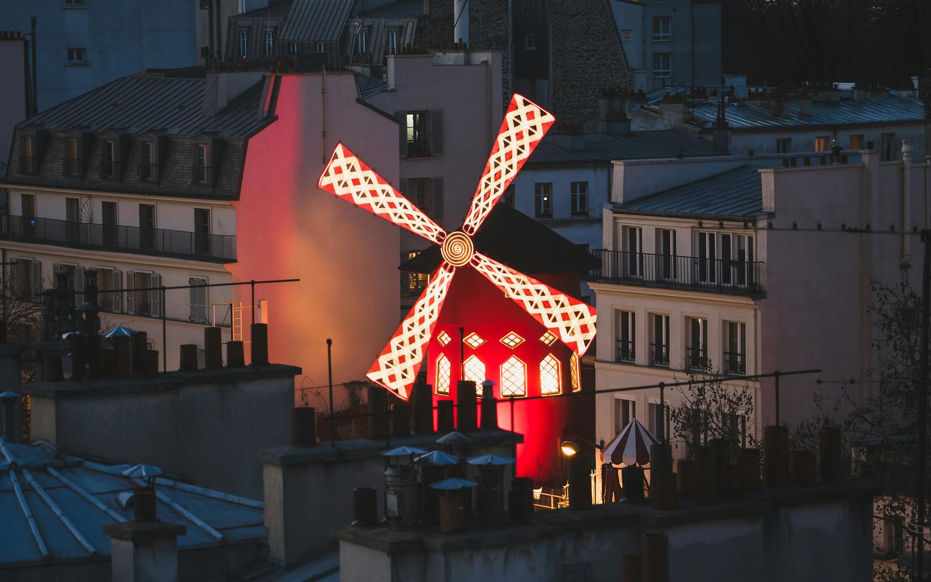 Vibrant cover image of Parisian cabaret scene with French cancan dancers and historic Montmartre windmill under lights