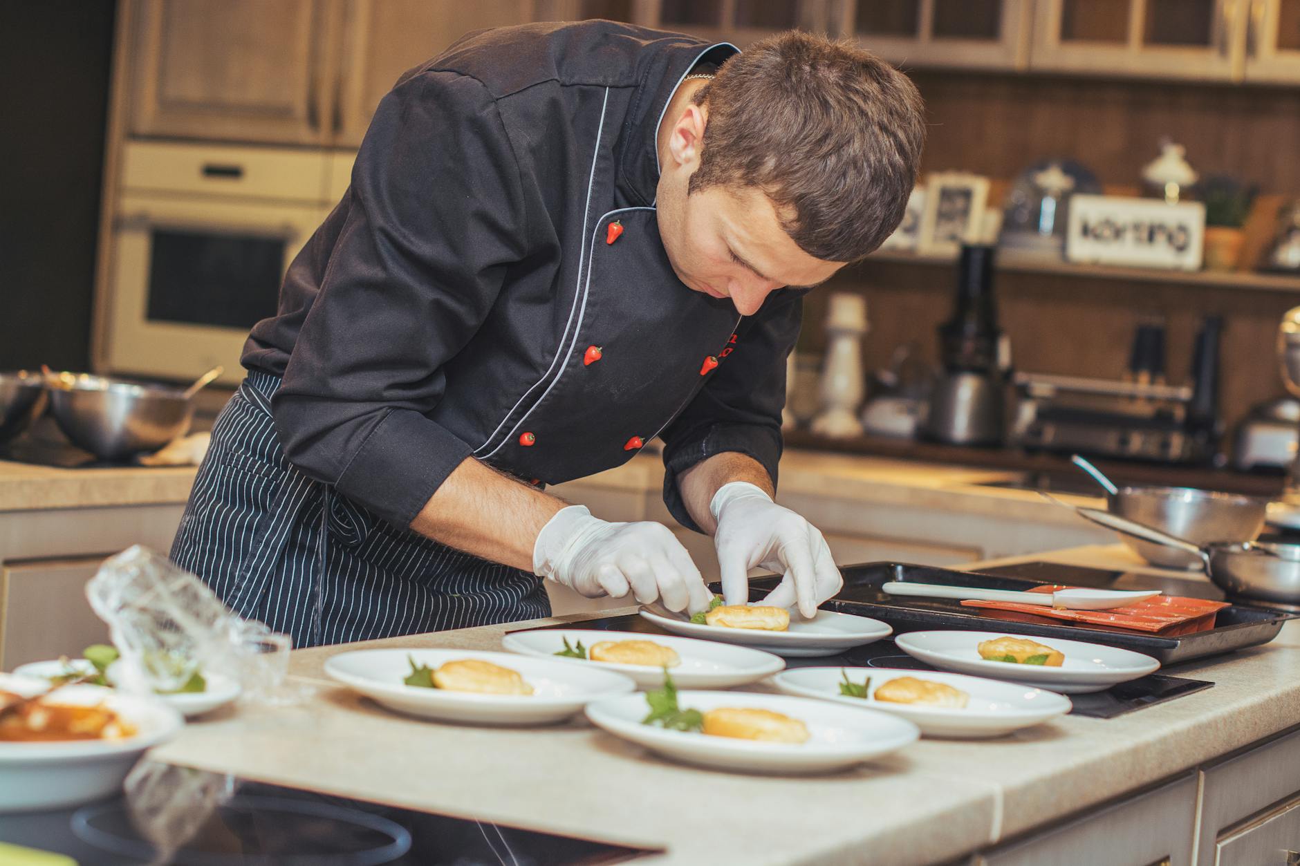 Intimate chef's table dining scene in Paris restaurant with chefs preparing dishes