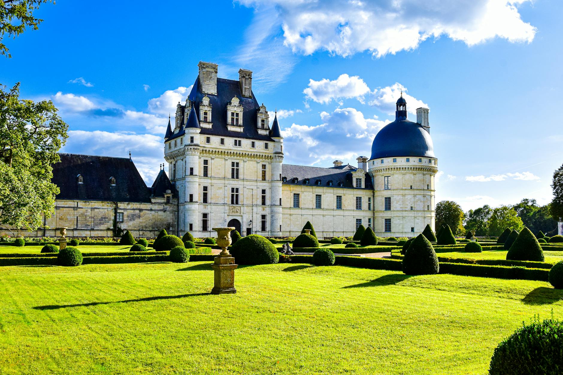Elegant view of Château de Valençay and manicured gardens on a bright summer day.