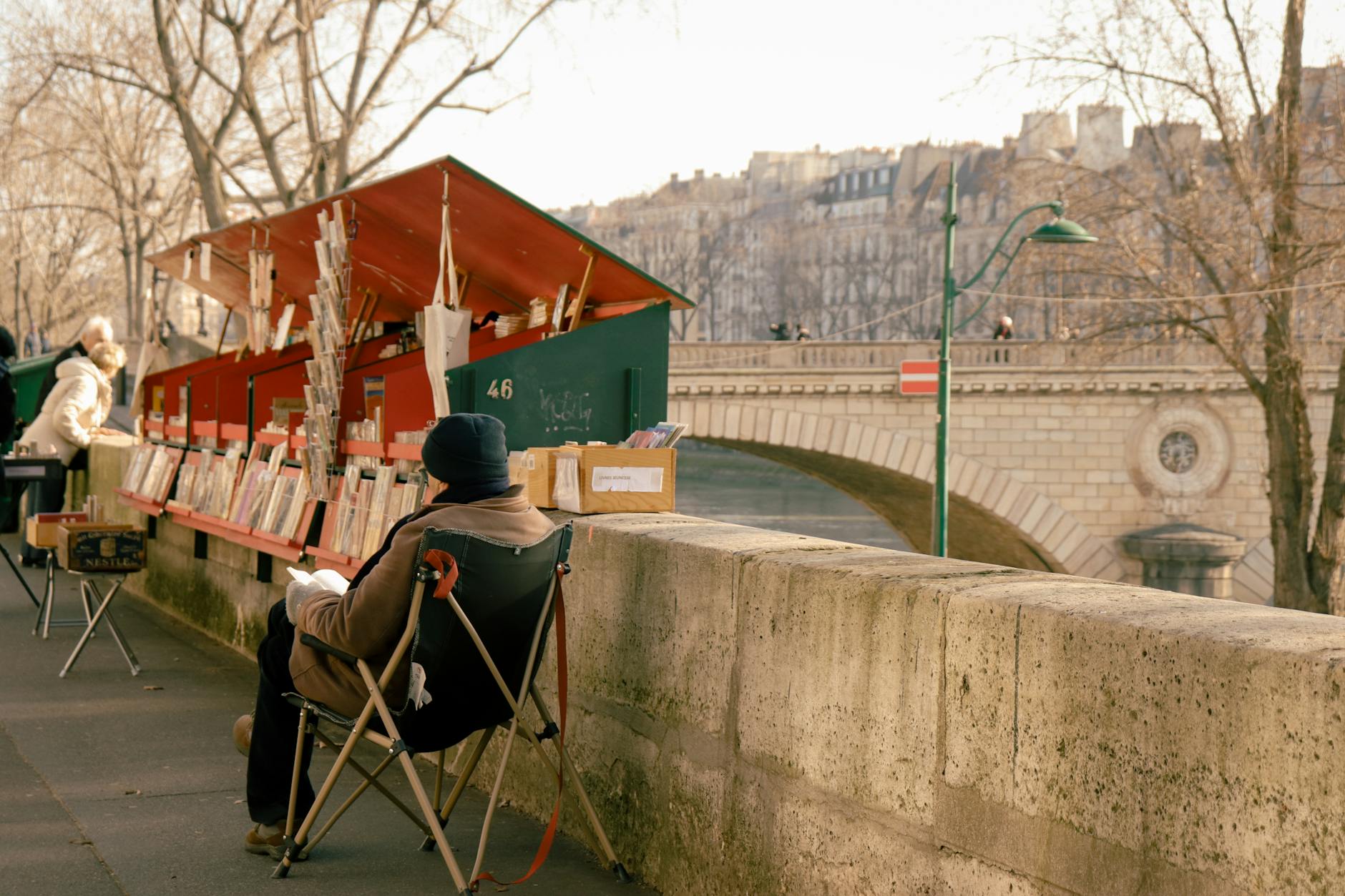 Charming scene of a bookseller stall by the River Seine in Paris, France.