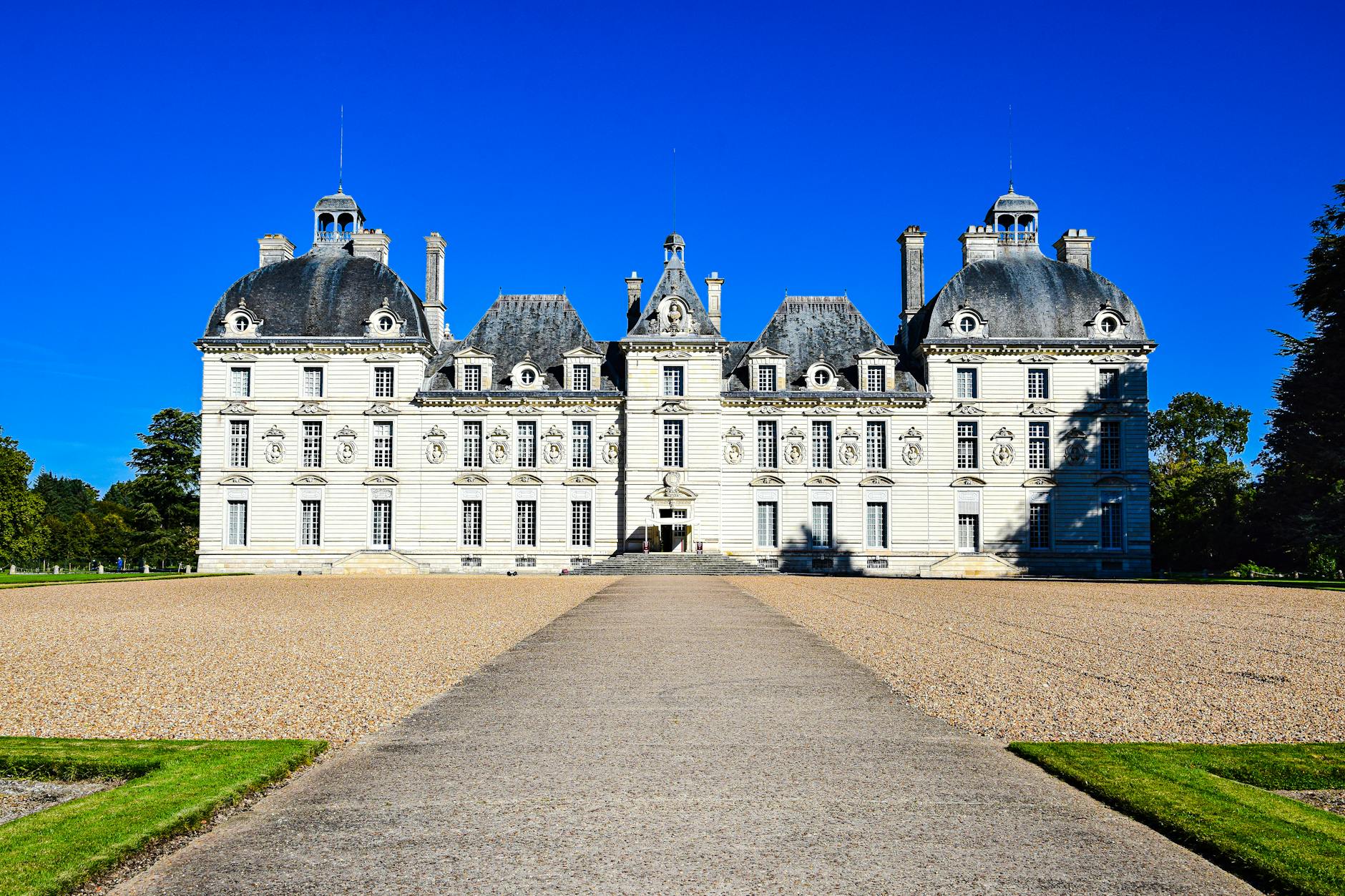 Stunning Château de Cheverny under a clear blue sky, showcasing its classical architecture.