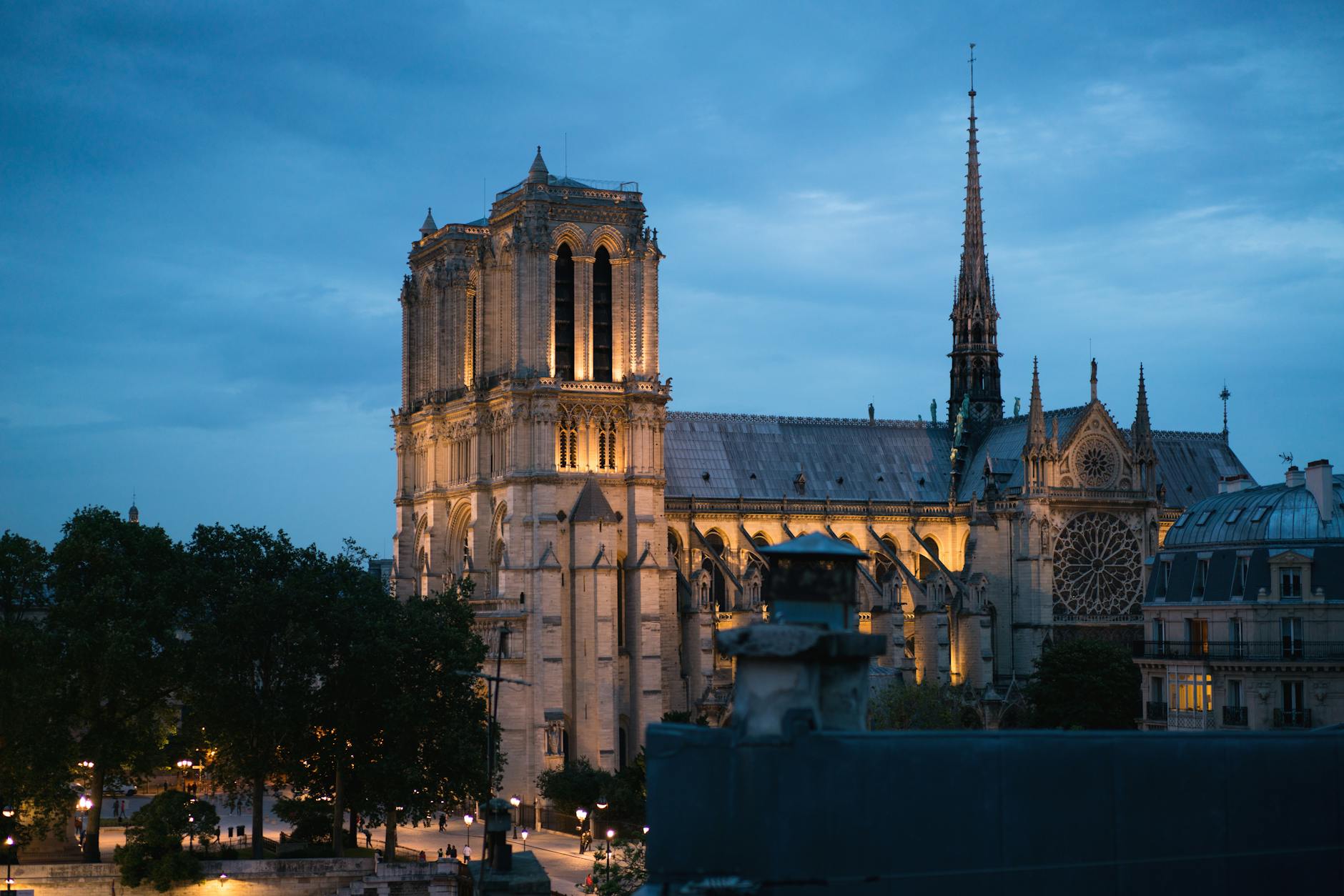 A stunning view of Notre Dame Cathedral illuminated at dusk in Paris, France.