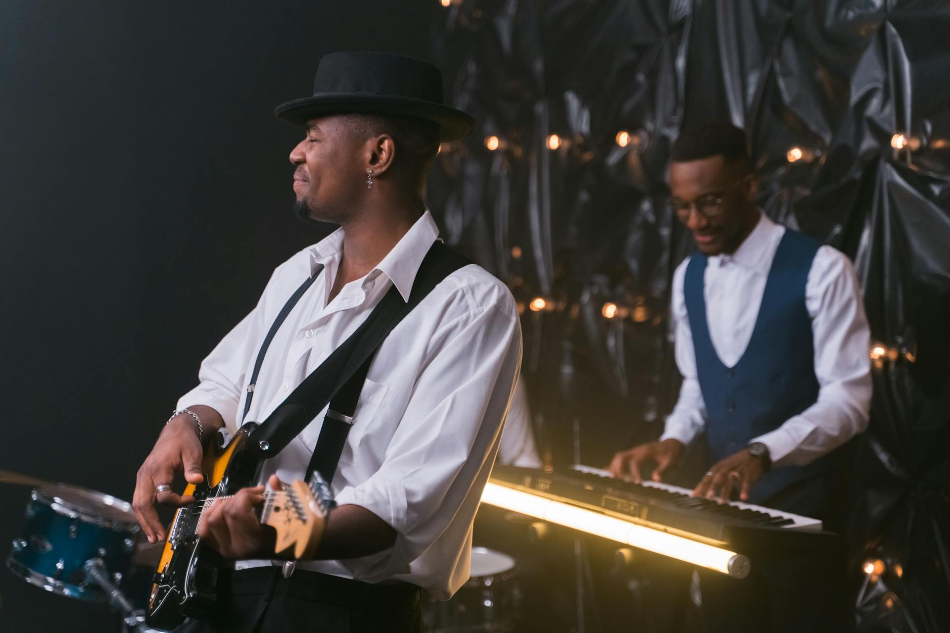 Energetic performance by jazz musicians with guitar and piano, creating soulful entertainment.