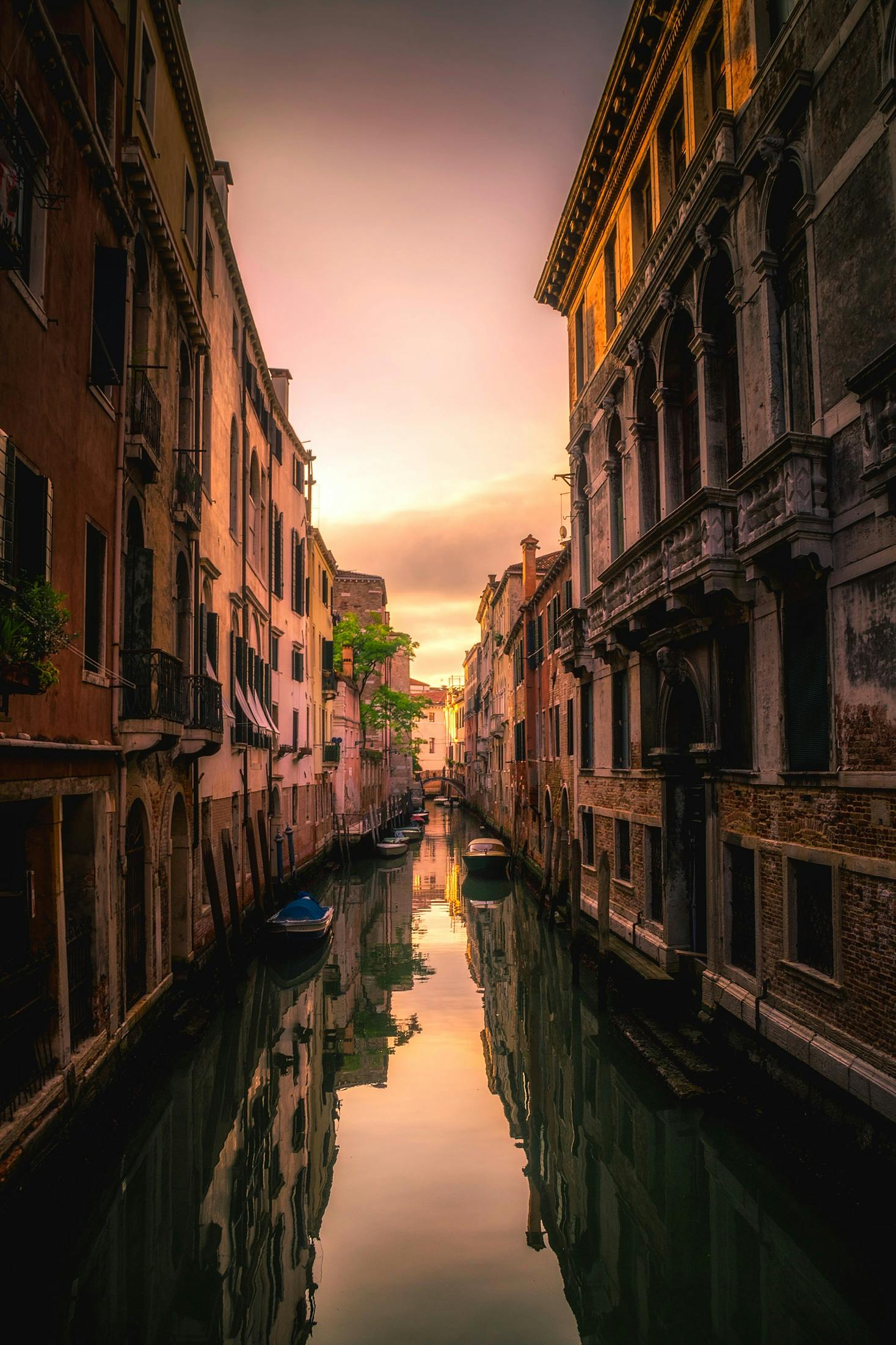 Venice canal with gondola at sunset - Italy