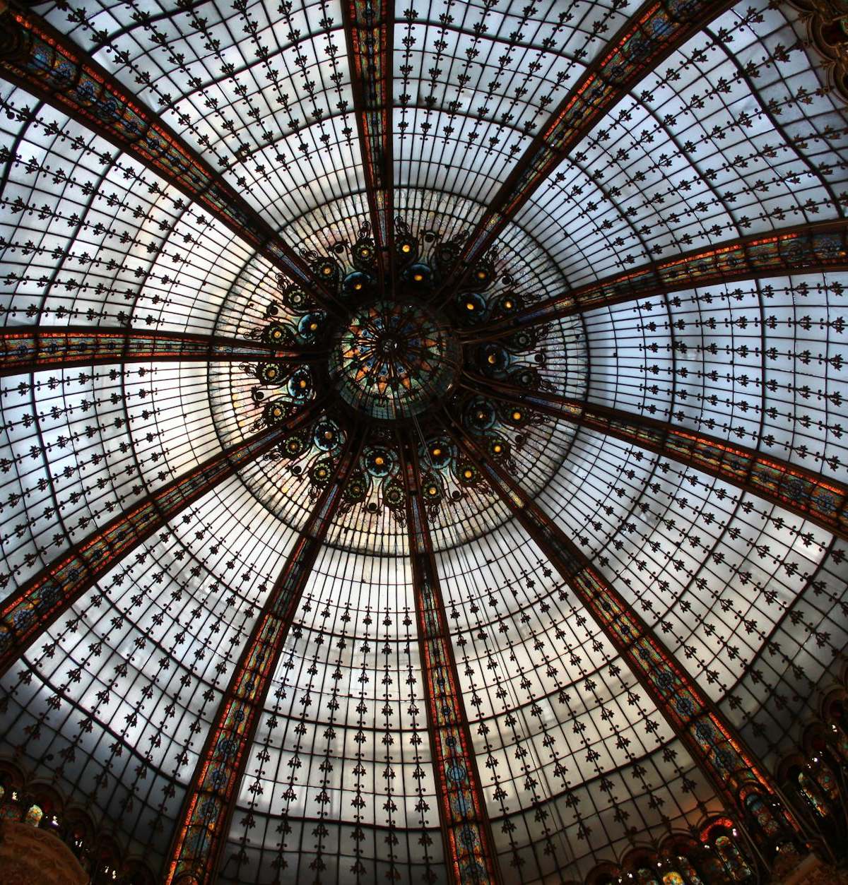 Elegant Belle Époque department store interior with grand glass canopy and iron framework in Paris