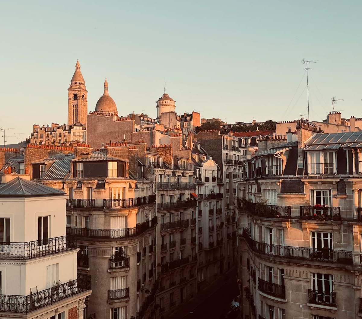 Parisian sunset over rooftops from Le Perchoir Marais terrace during apéro hour