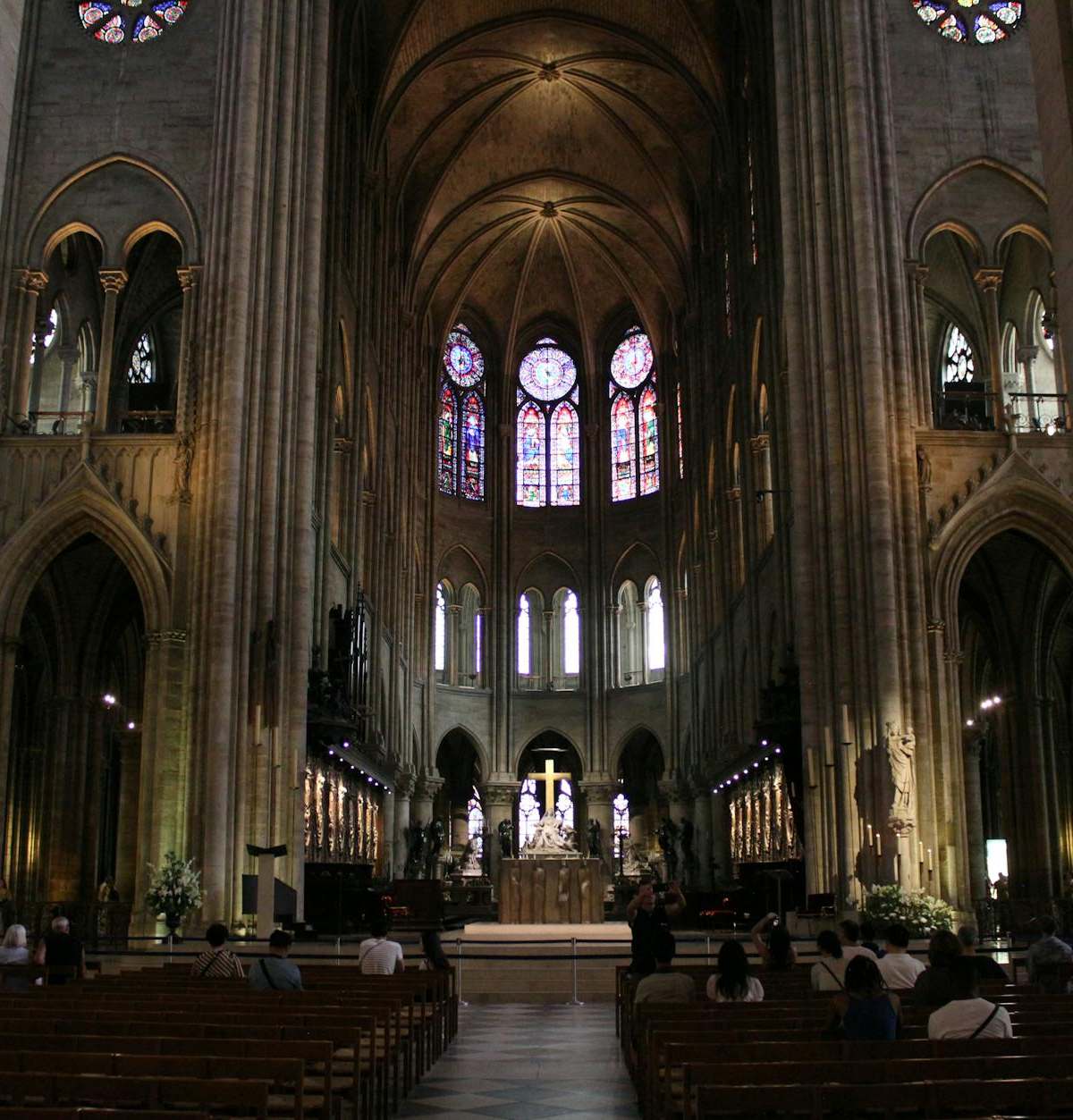 A majestic view of the Notre-Dame Cathedral interior in Paris, showcasing Gothic architecture.