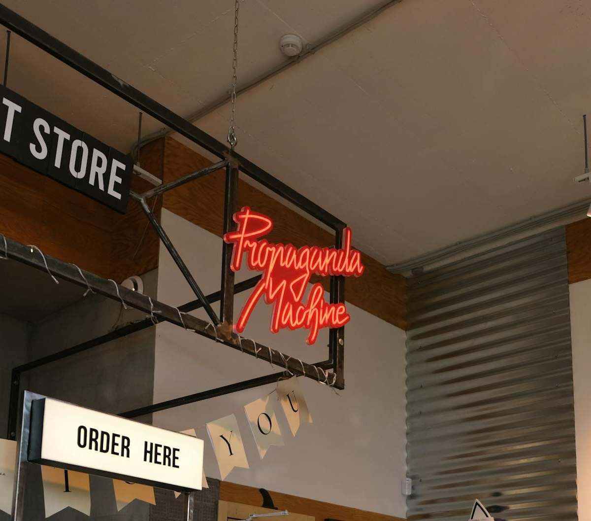 Interior of a modern concept store featuring neon signage and contemporary decor.