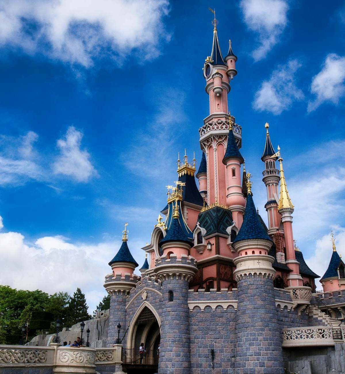 Magical view of the iconic Disneyland Paris castle with a vibrant blue sky.