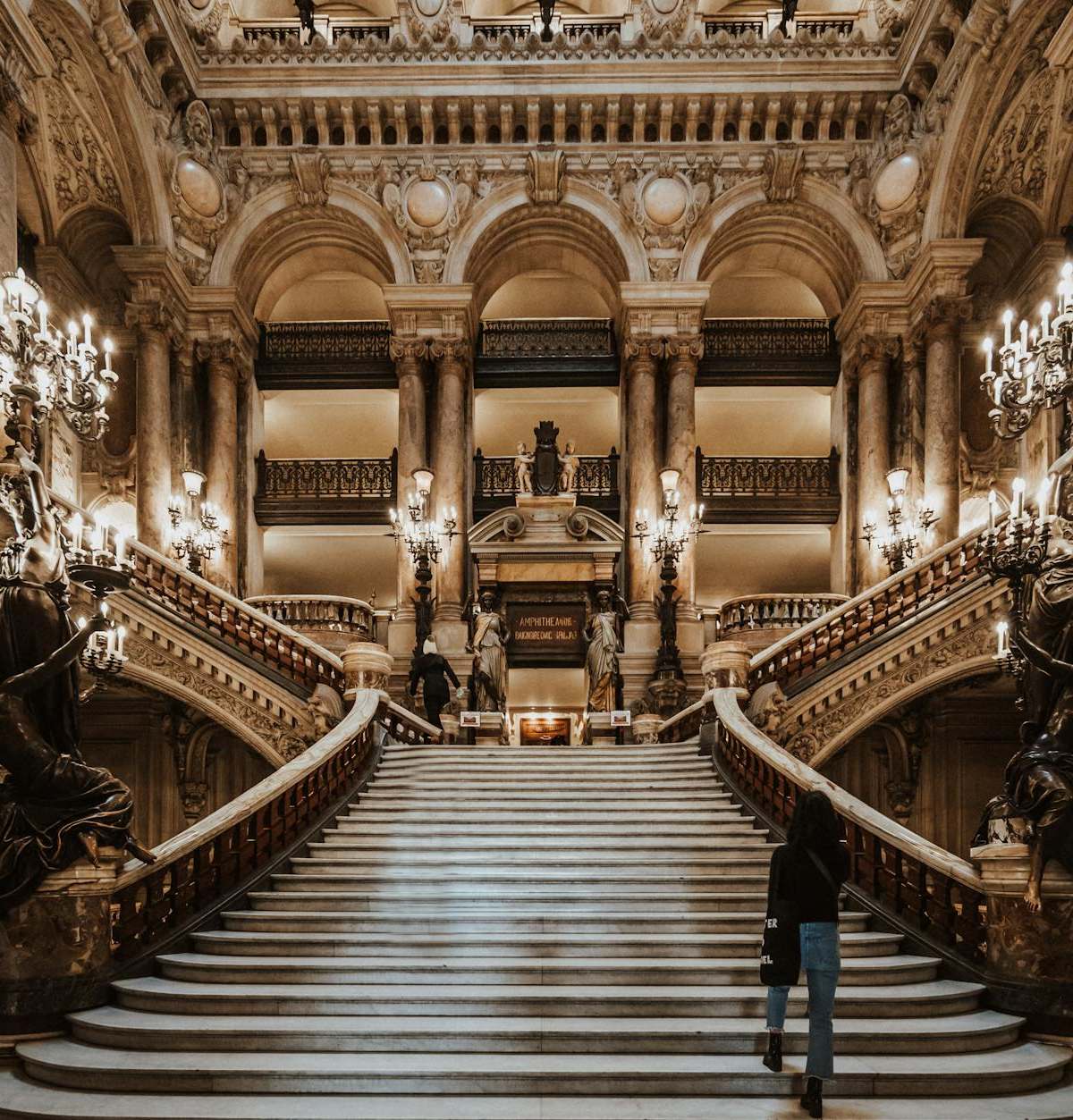Elegant evening scene at Palais Garnier opera house with velvet seats, gold details, and chandelier glow