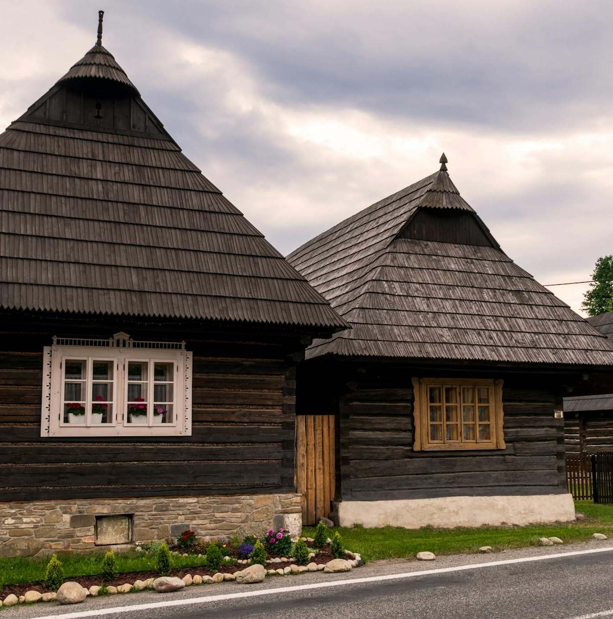 Charming wooden cottages in Podbiel, Slovakia, showcasing traditional architecture.