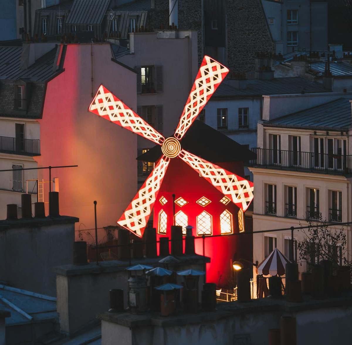 Vibrant cover image of Parisian cabaret scene with French cancan dancers and historic Montmartre windmill under lights