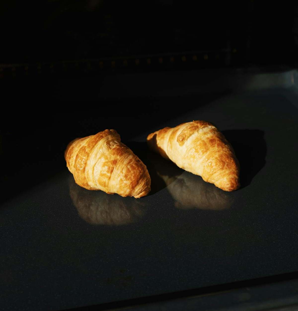 Hands-on croissant baking workshop in a Paris boulangerie, showing lamination and golden pastries