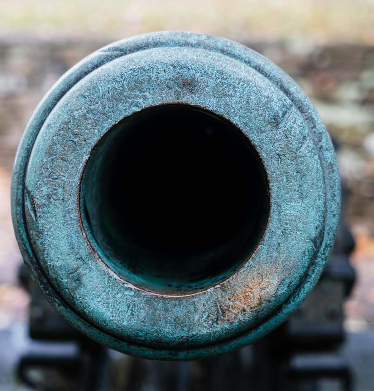 Detailed shot of a historic cannon barrel with patina.