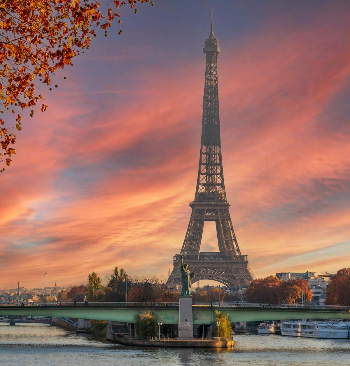 Stunning view of the Eiffel Tower during a colorful autumn sunset in Paris.