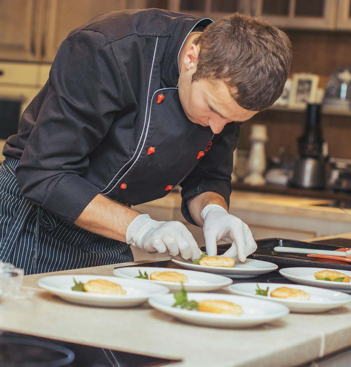Intimate chef's table dining scene in Paris restaurant with chefs preparing dishes