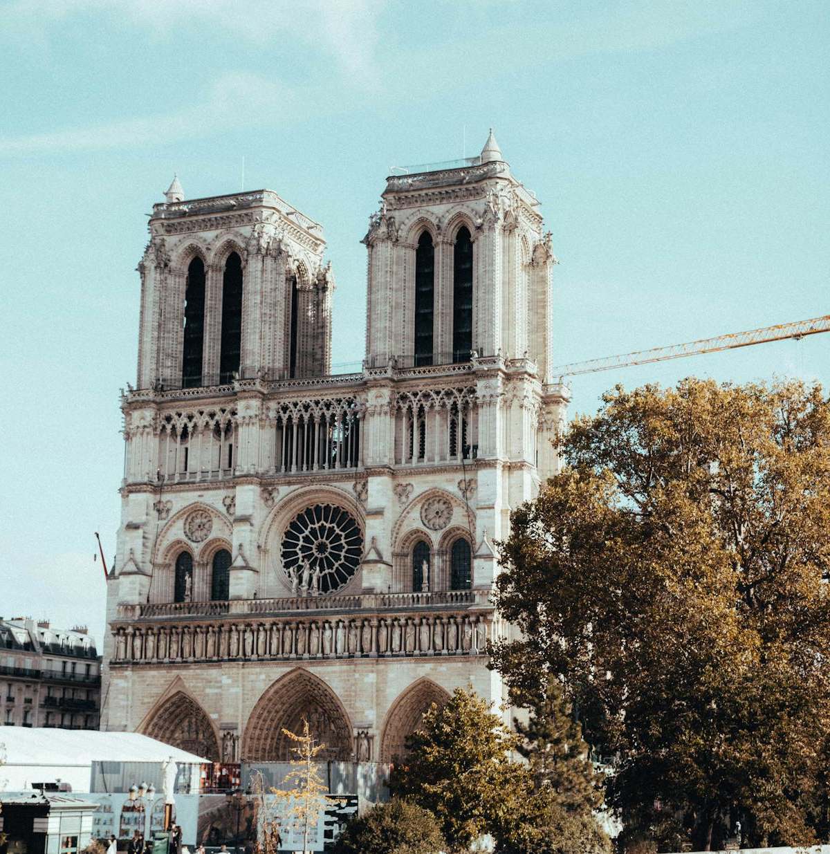 View of the iconic Notre Dame Cathedral in Paris during restoration work with cranes visible.
