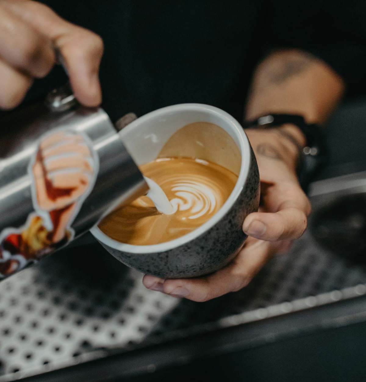 Modern Paris café scene with barista pouring specialty coffee in minimalist industrial setting