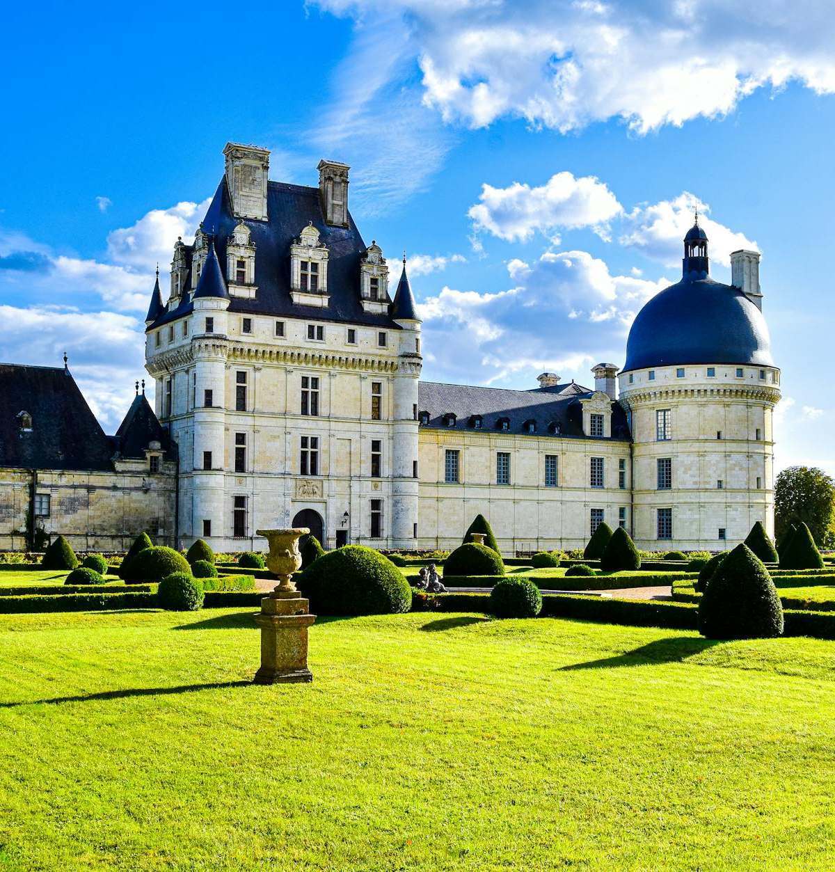 Elegant view of Château de Valençay and manicured gardens on a bright summer day.