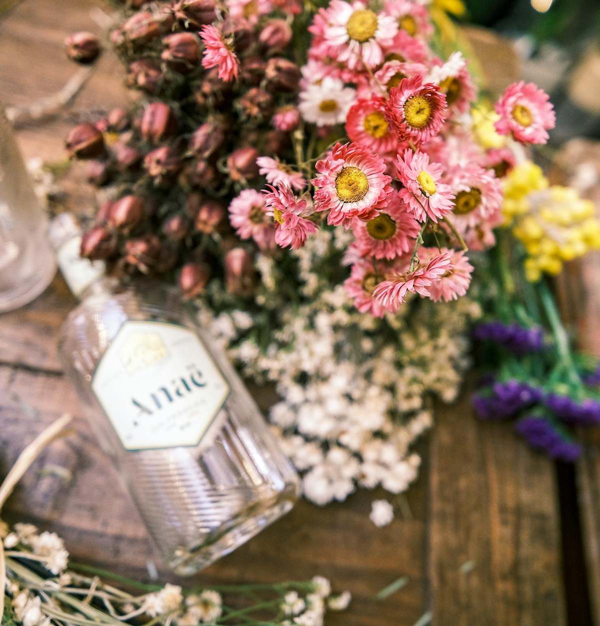 A vibrant floral display on a rustic wooden table in Paris, showcasing natural beauty.