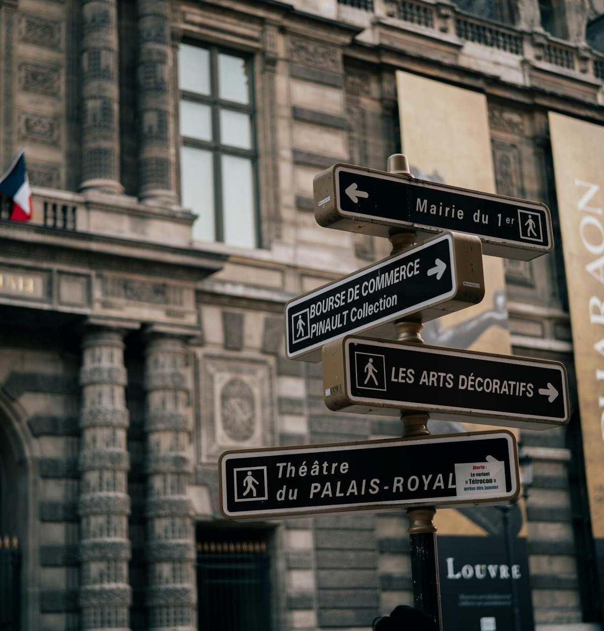 Street signs near historic Palais Royal in Paris, France. Architectural elegance and cultural landmarks.