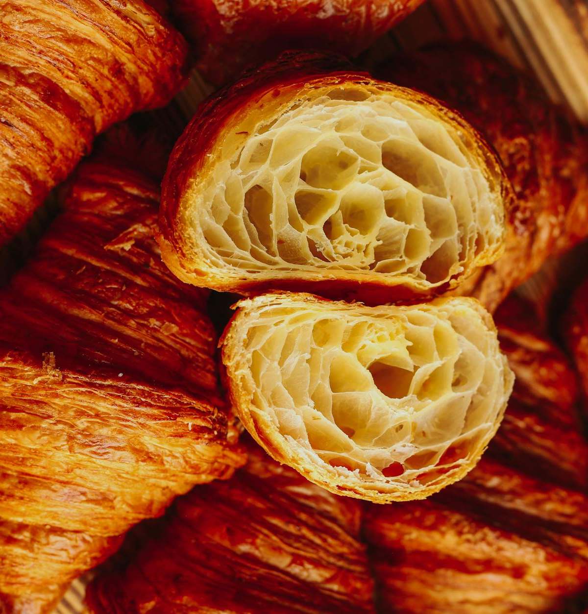 Delicious freshly baked croissants, golden and flaky, perfect for breakfast or brunch.