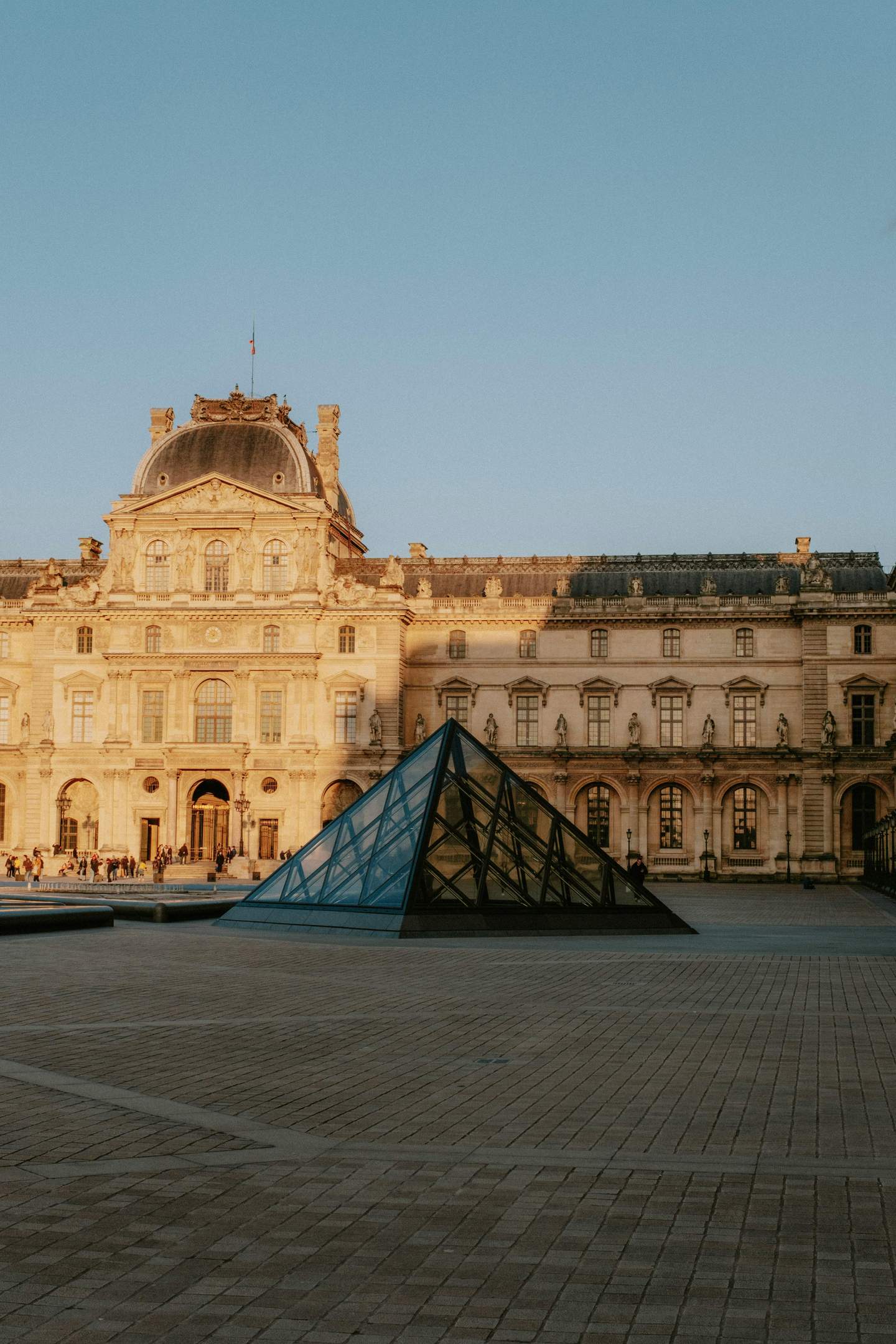Stunning view of the Louvre Museum with its iconic glass pyramid in Paris
